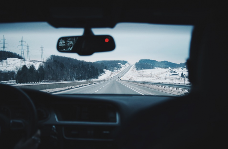 Woman driving car on snowy road