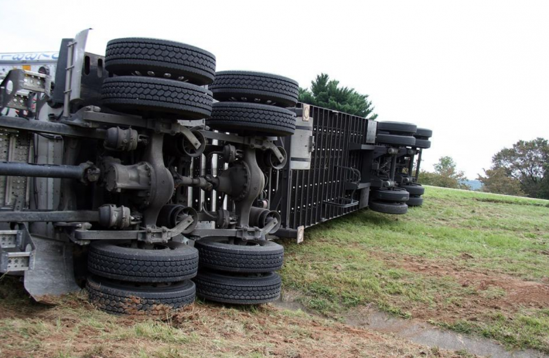 Semi-truck turned on side after car accident