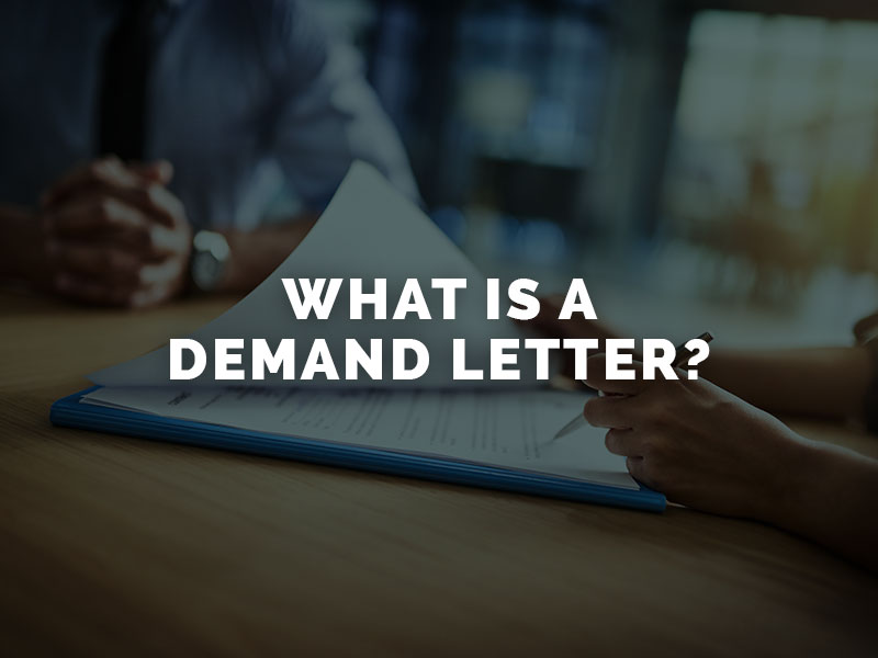 Lawyer writing a demand letter on a desk