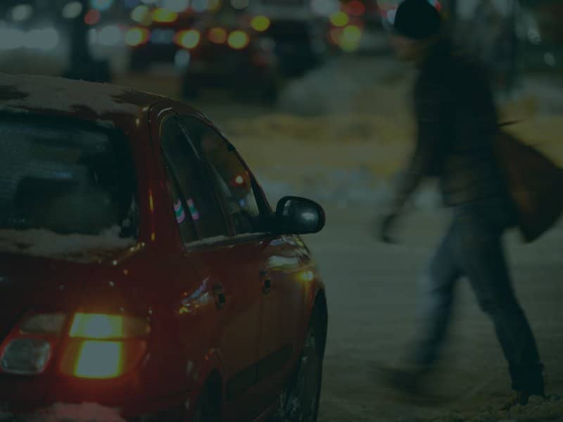 Man crossing the street about to be hit by a car