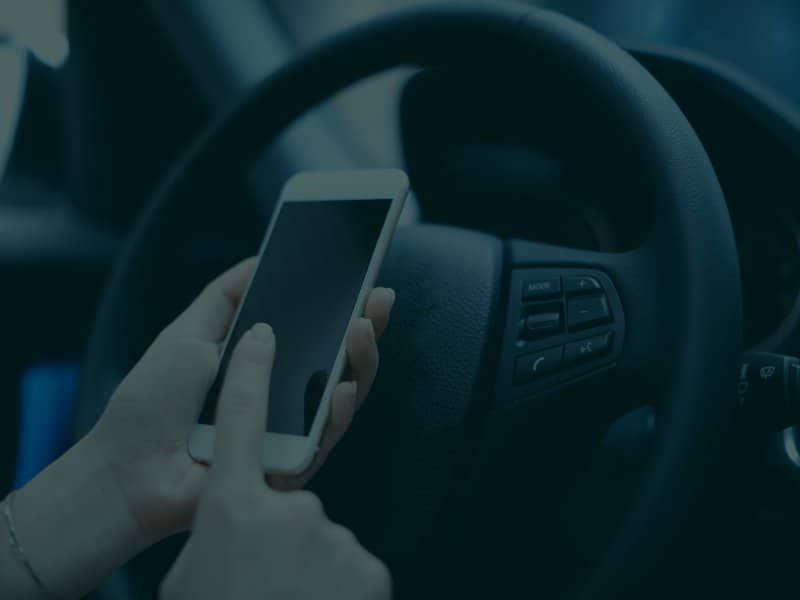 Woman using her phone while driving