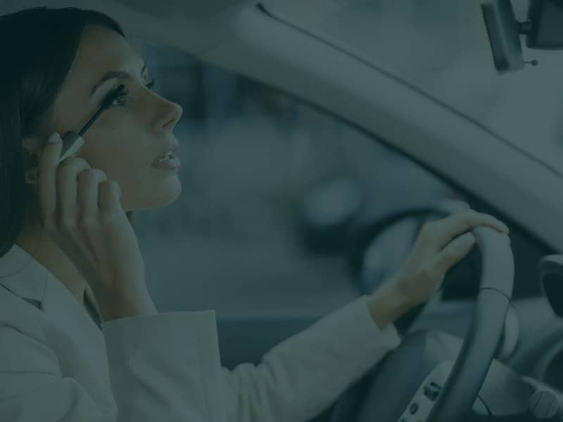Woman Putting on Makeup while Driving